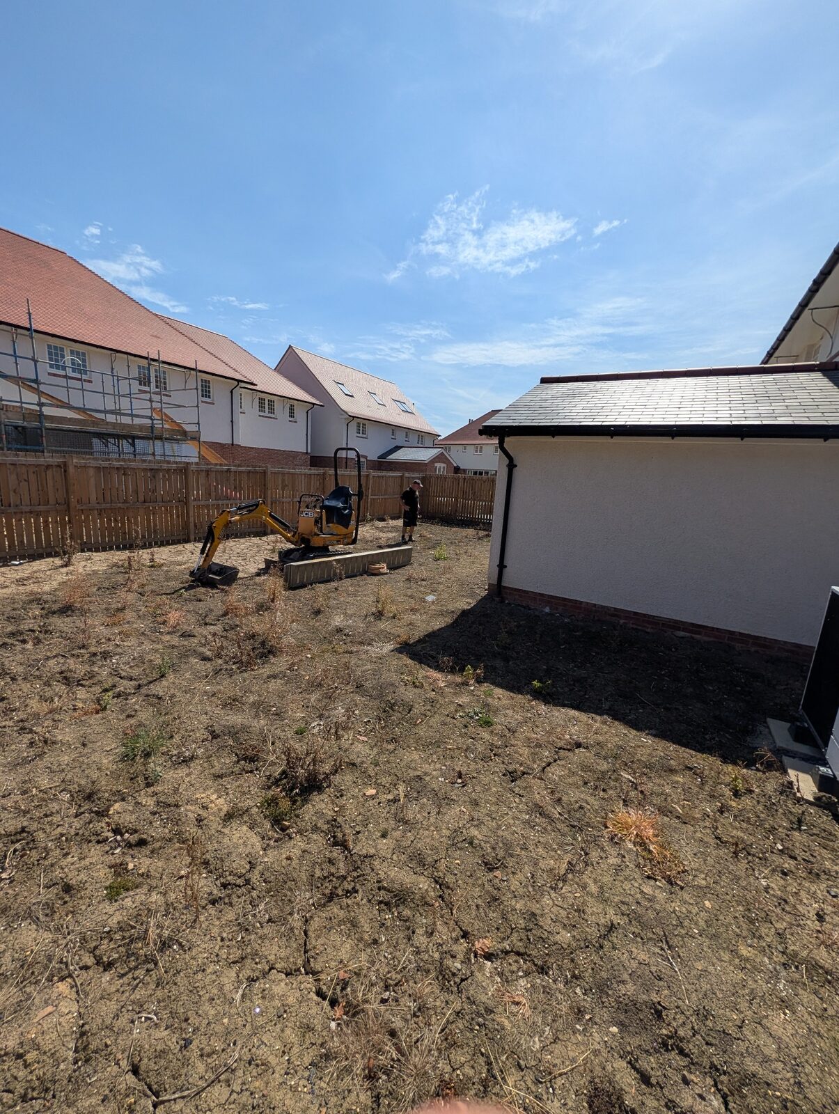 Cleared garden with machinery on site
