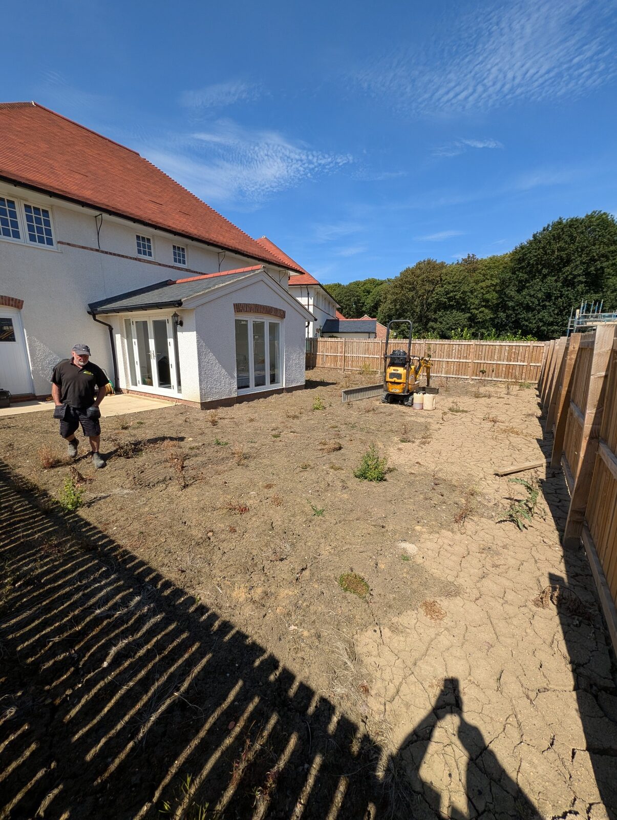 Greenfingers team working across the cleared garden