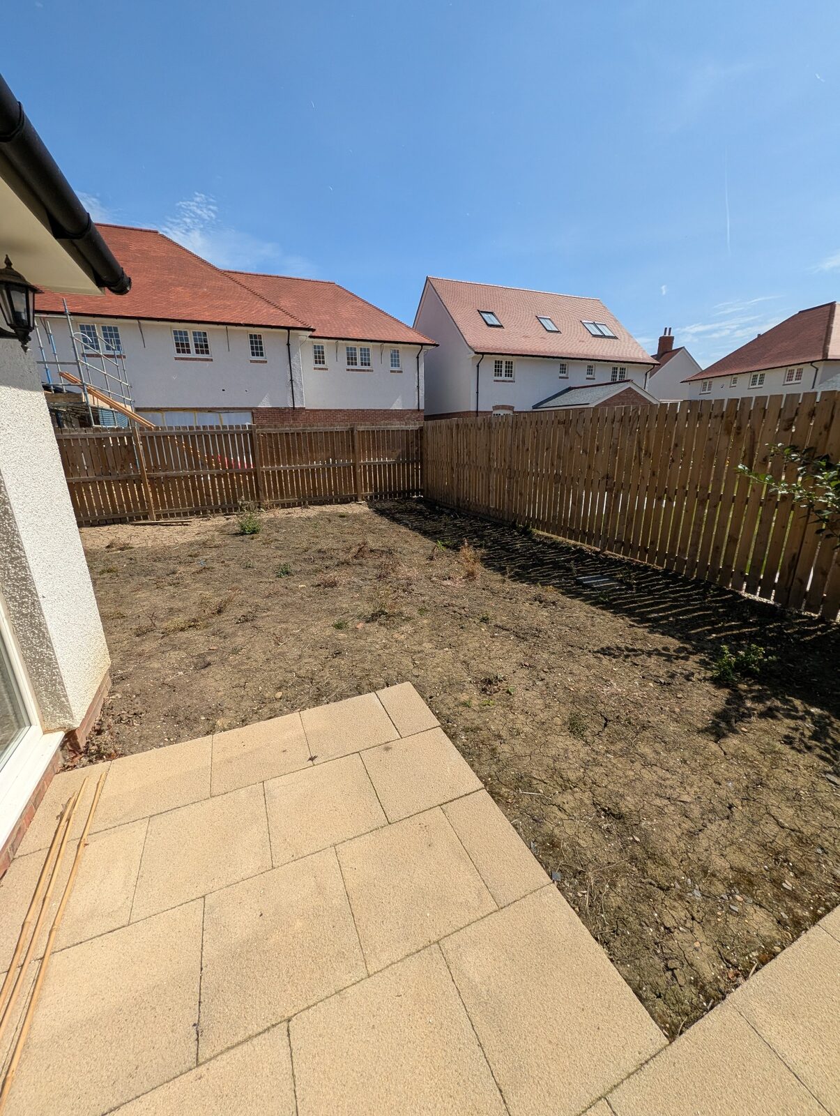 Existing patio and cleared garden at the start of the project