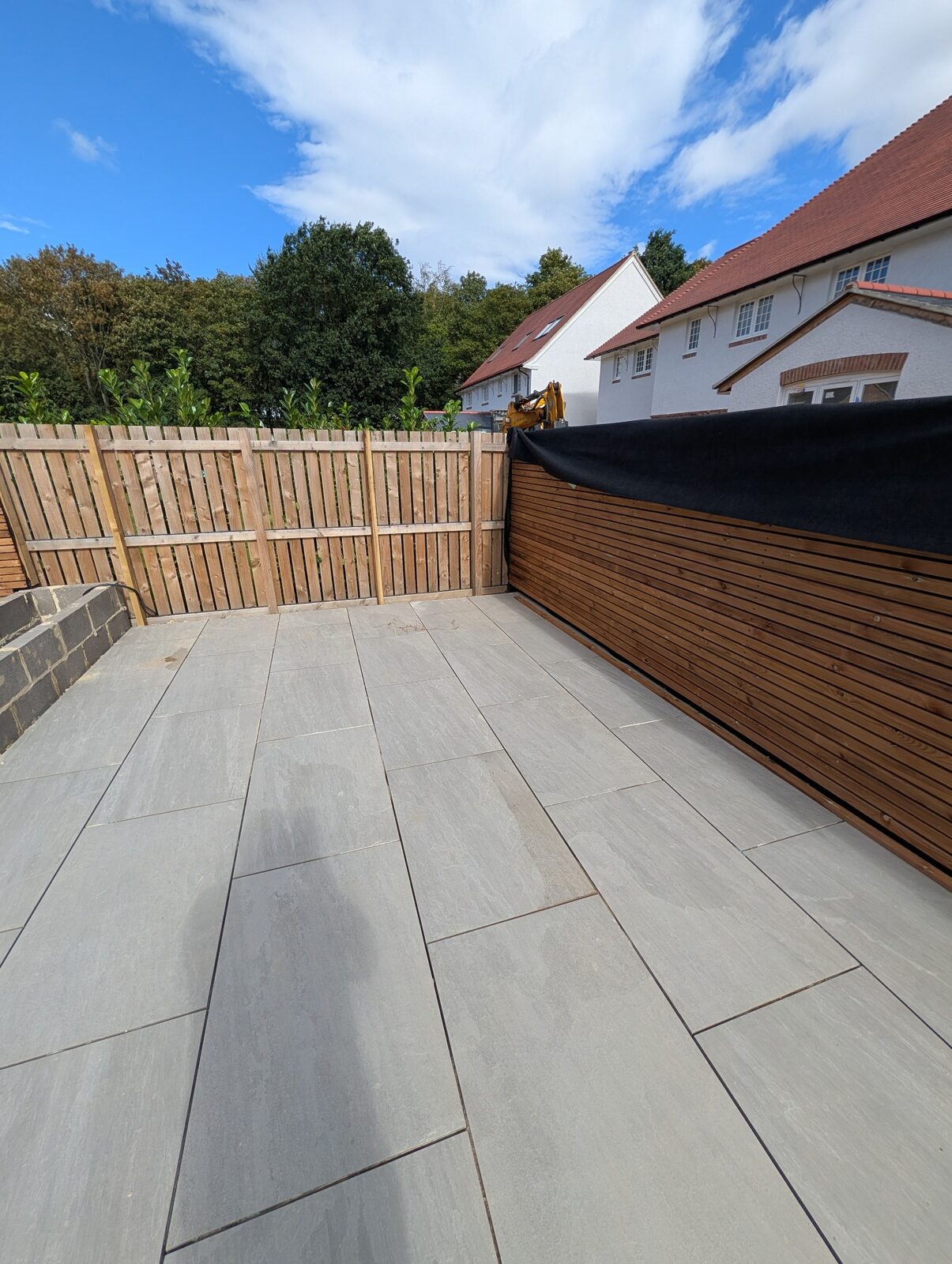Broad paved area with timber screening