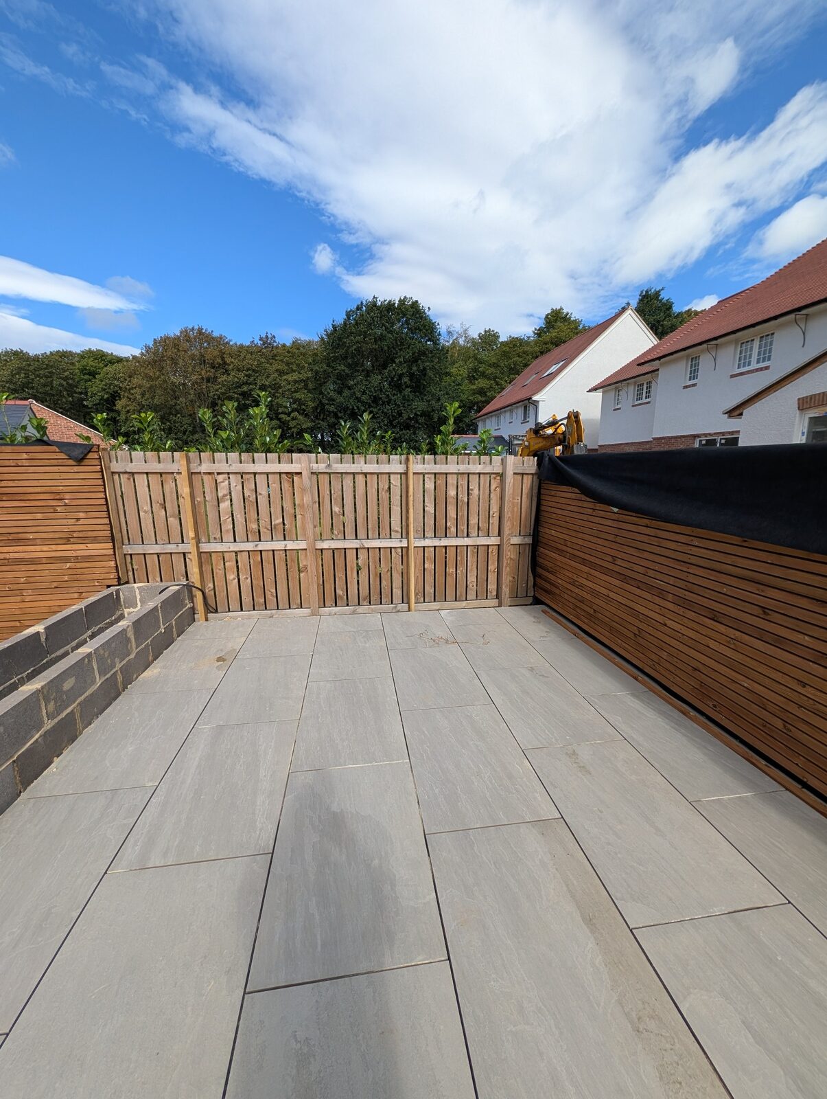 Latest paved area framed by timber screening